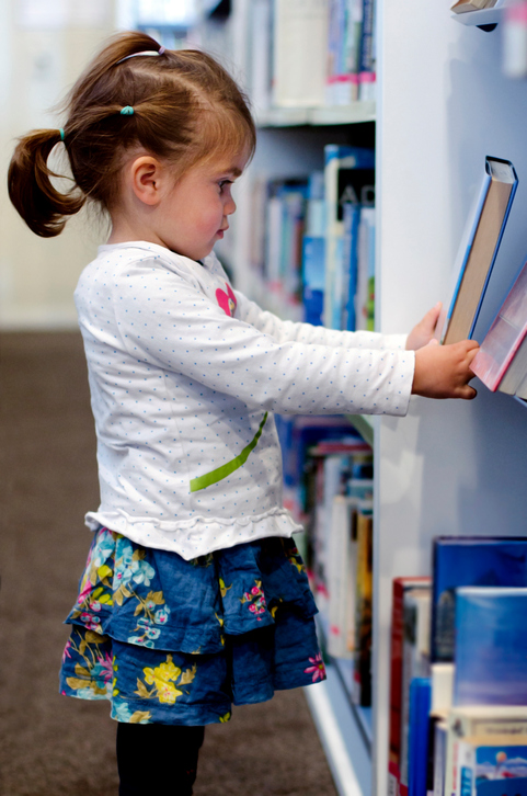 preschool girl selecting book